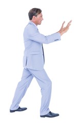  Businessman walking while gesturing with hands