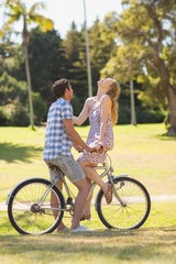 Young couple on a bike ride in the park