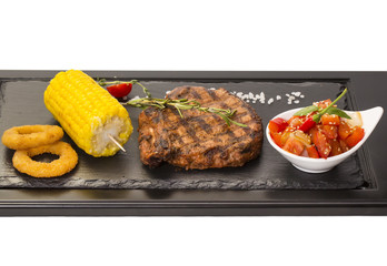 Grilled steak with sauce and greens 