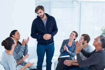 Fototapeta premium Rehab group applauding delighted man standing up