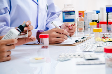 two pharmacists preparing prescription and medicine box

