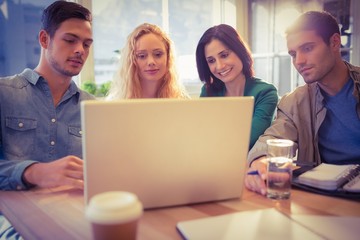 Group of young colleagues using laptop