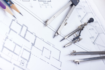 Architectural project, blueprints, blueprint rolls and divider compass, calipers, folding ruler on plans Engineering tools view from the top. Copy space. Construction background.