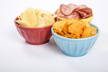 Three Colorful Bowls Filled with Various Flavors of Potato Chips