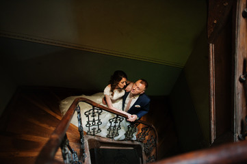 Just married in the wooden stairs of an ancient building