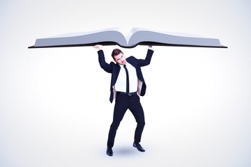 Composite image of businessman in suit lifting up something heav