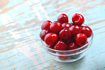 Sweet Cherry in Glass Bowl on Rustic Table