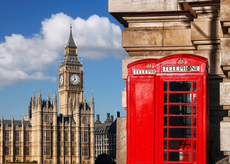 Fototapeta na wymiar English red telephone booths with Big Ben in London, UK