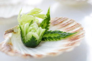 cook prepares appetizer with scallops