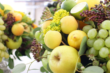 bouquet of fruits: apples, grapes, lemon, lime tangerine, melon, physalis, apricot