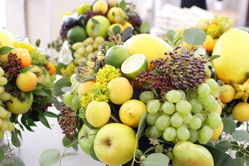 bouquet of fruits: apples, grapes, lemon, lime tangerine, melon, physalis, apricot
