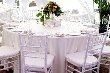 Fototapeta na wymiar white chairs, white tablecloths on the tables in the restaurant