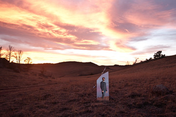 Reflection of a man in a mirror in the countryside, USA