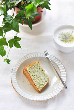Slice of matcha cake and green tea latte drink