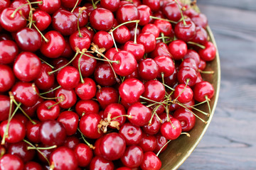 dish with fresh cherries closeup