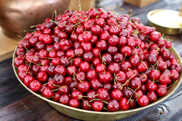 dish with fresh cherries closeup