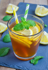 Refreshing homemade lemon iced tea on a black slate tray