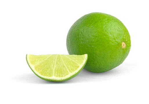 Limes with slices isolated on white background