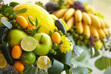Fruit basket close-up: bananas, apples, grapes, apricots, melon,