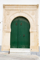 Fototapeta na wymiar Locked Wooden Front Door of the Old House in Mahdia, Tunisia