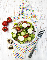 Spring salad with eggs, tomato, cucumbers and radish