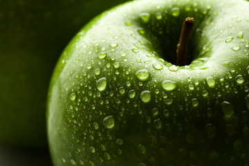 apple in green with water drops on its surface
