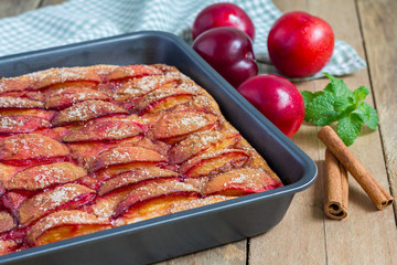 Homemade plum pie in a baking dish