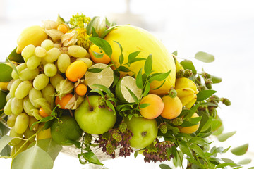 Fruit basket close-up: bananas, apples, grapes, apricots, melon,