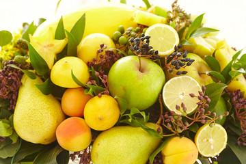 Fruit basket close-up: bananas, apples, grapes, apricots, melon,