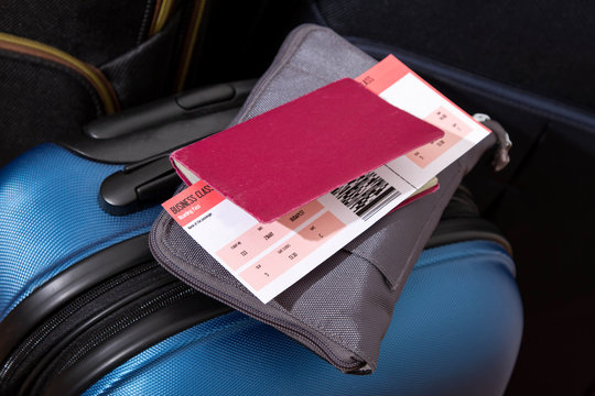 Airline ticket, passport and luggage.