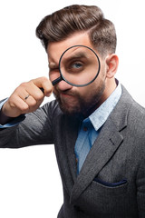 Man with magnifying glass on white background