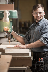 Woodworker using drilling machine