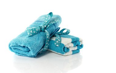 two rolled towels blue and white