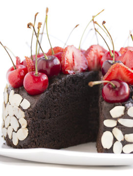 Chocolate cake with cherries on a white background.