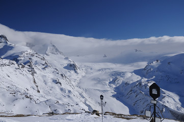 Photography of white mountains in a sunny winter day with an infinite blue sky
