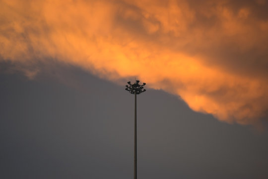 Electricity post and orange clouds