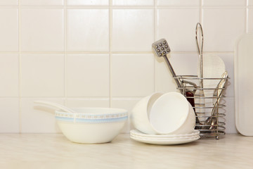 White kitchenware on kitchen table.