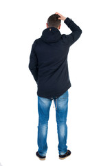 Back view of handsome man in winter jacket  looking up. © ghoststone