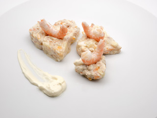 Russian salad with king prawns on white plate
