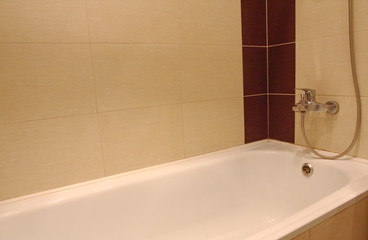 Bath tub with chrome faucet.