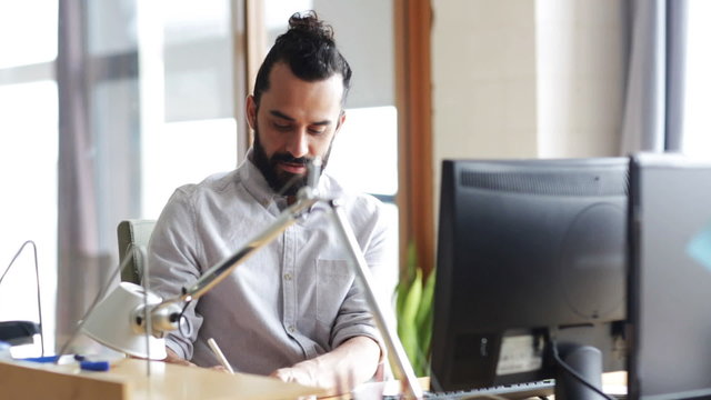 happy creative male office worker with computer