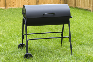Drum Barrel Charcoal BBQ - Oil barrel style barbecue in garden.     © paul_brighton