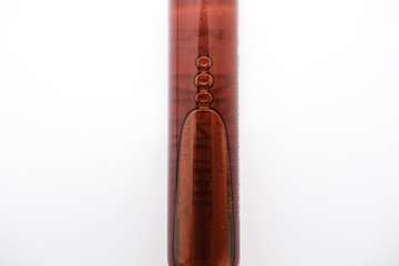 Red phial. Ampule isolated in white background