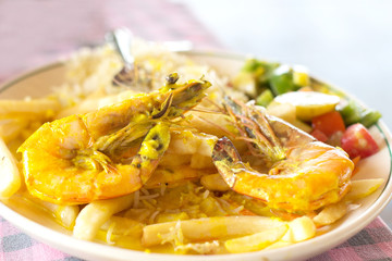 Royal shrimps with French fries rice and salad, selective focus