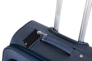 Travel suitcase close up isolated on white with black name tag