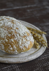 homemade rustic bread on a dark wooden background
