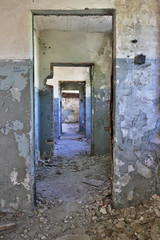 Ruins of a huge empty factory building, abandoned door