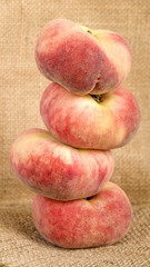 Saturn Peach - Doughnut peaches on a rustic background.
