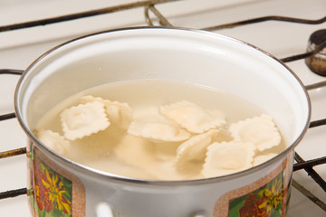 the dumplings cooks in a pan with the boiling water