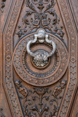 Ancient door with silver knocker in Granada, Spain
